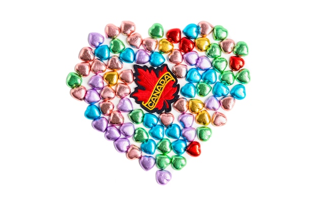 Premium Photo | A canada badge and heart shape candies