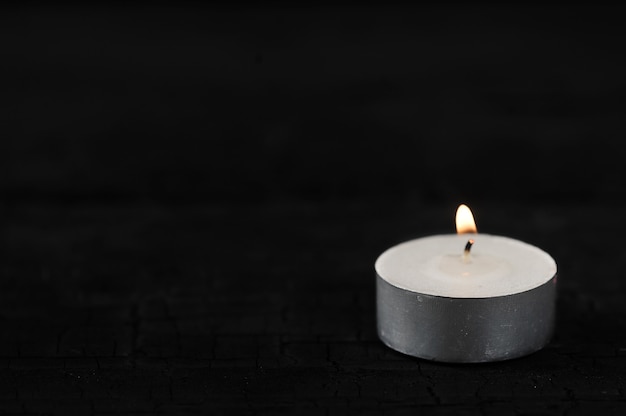 Premium Photo | Candle with burning fire on black