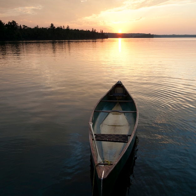 Canoe floating on the water at lake of the woods, ontario ...