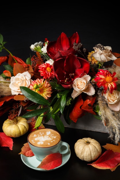 Premium Photo Cappuccino And Beautiful Flowers Bouquet Still Life Flower Shop Composition Coffee Cup Pumpkins On Black Wooden Table Florist Art And Floral Design Concept