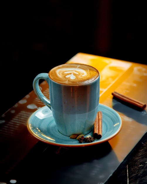 Cappuccino served in blue cup Free Photo