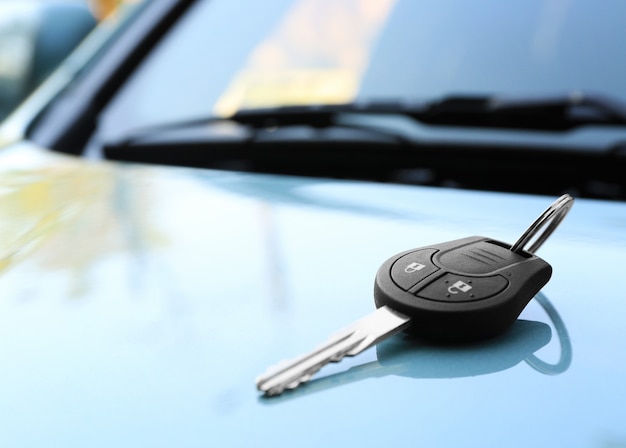 Download Premium Photo | Car key on hood outdoors