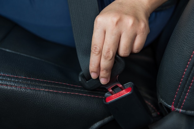 Premium Photo | Car seat belt. woman fastens the seat belt on car safe