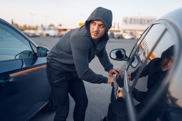 Premium Photo | Car Thief Breaking Door Lock, Criminal Lifestyle ...