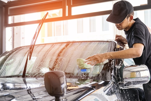 Premium Photo Car Wash Worker Using A Sponge To Clean The Car In The