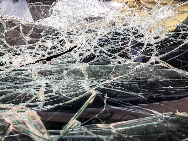 Premium Photo | Car windshield shattered with stones by vandals.