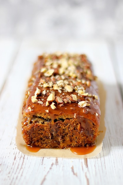 Caramel brownie pie with minced peanuts and nuts on it Free Photo