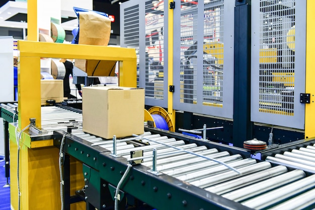 Premium Photo | Cardboard boxes on conveyor belt in distribution warehouse