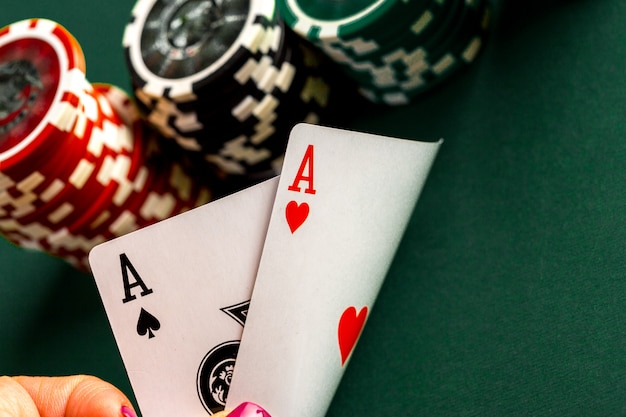 Cards and chips for poker on green table Premium Photo