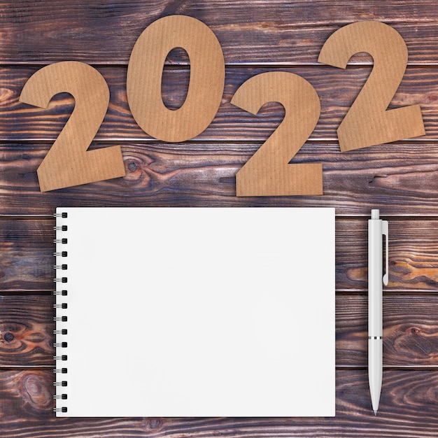 premium-photo-cardstock-numbers-2022-happy-new-year-sign-near-white-spiral-paper-cover