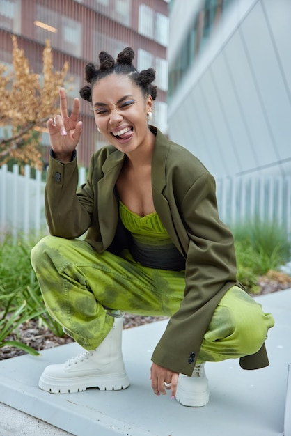 Premium Photo | Carefree hipster girl with hair buns and makeup feels ...