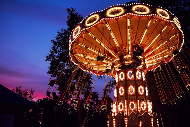 Premium Photo | Carousel merry-go-round in amusement park at evening city