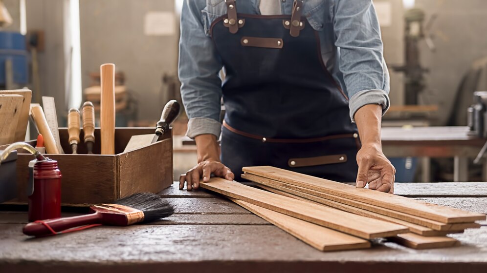 Premium Photo | Carpenter working with equipment on wooden table in ...