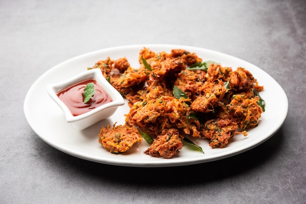 Premium Photo | Carrot fritters or gajar ke pakore or pakode or bajji ...