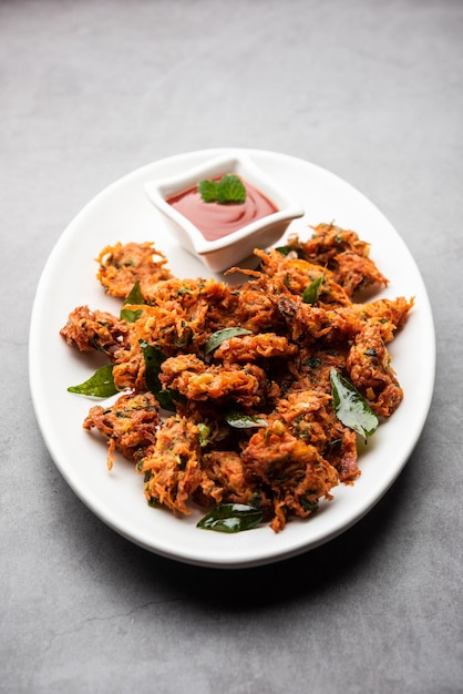 Premium Photo | Carrot fritters or gajar ke pakore or pakode or bajji ...