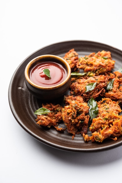 Premium Photo | Carrot fritters or gajar ke pakore or pakode or bajji ...