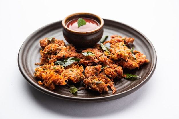 Premium Photo | Carrot fritters or gajar ke pakore or pakode or bajji ...