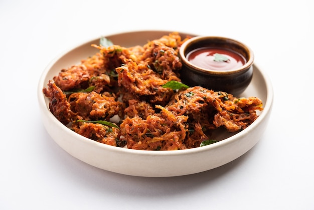 Premium Photo | Carrot fritters or gajar ke pakore or pakode or bajji ...