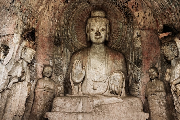 Premium Photo | Carved buddha limestone at longmen grottoes or caves ...