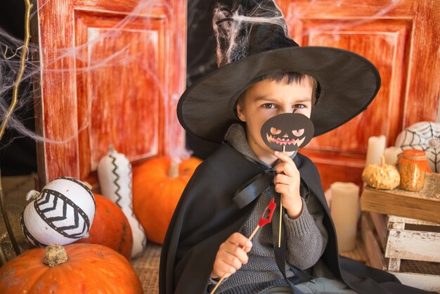 Premium Photo | Caucasian boy in carnival wizard costume with black ...