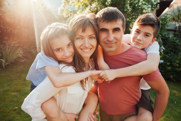 Caucasian parent carrying their children in park Photo | Free Download