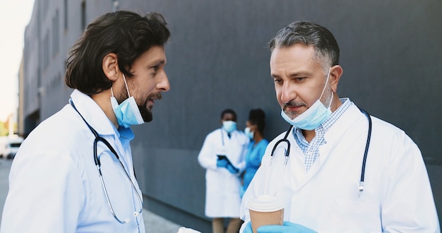 Premium Photo | Caucasian two men, doctors coleagues talking and ...