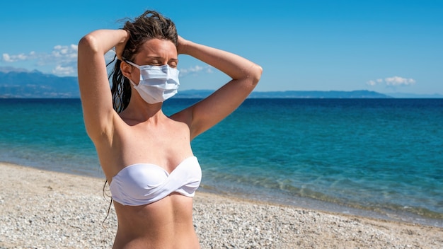 Free Photo Caucasian Woman In White Medical Mask With Raised Hands To