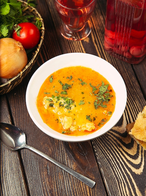 Free Photo | Cauliflower soup in chicken tomato broth with herbs.