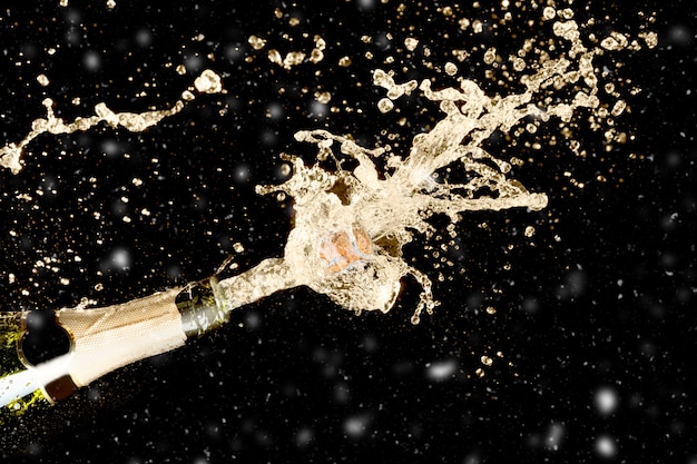 Premium Photo | Celebration theme with splashing champagne on black ...