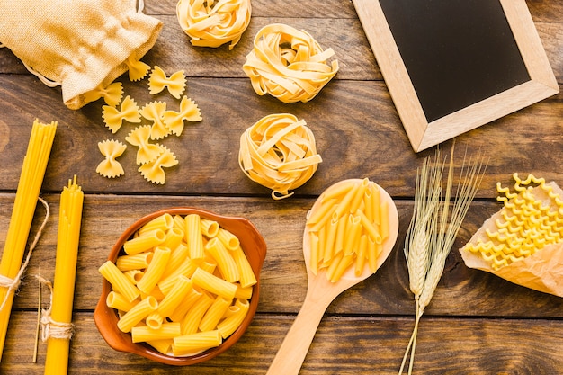 Free Photo | Chalkboard and wheat near pasta