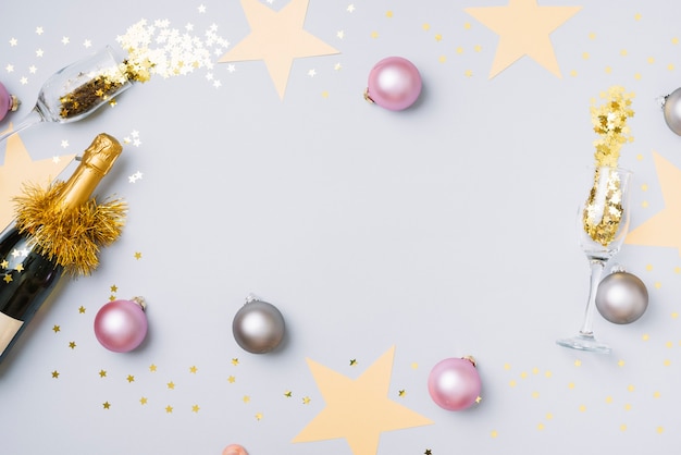 Champagne bottle with baubles on table Free Photo