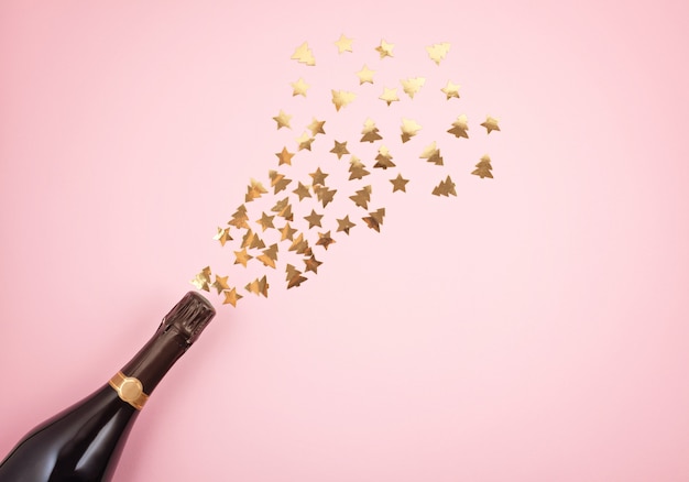 Premium Photo | Champagne bottle with confetti