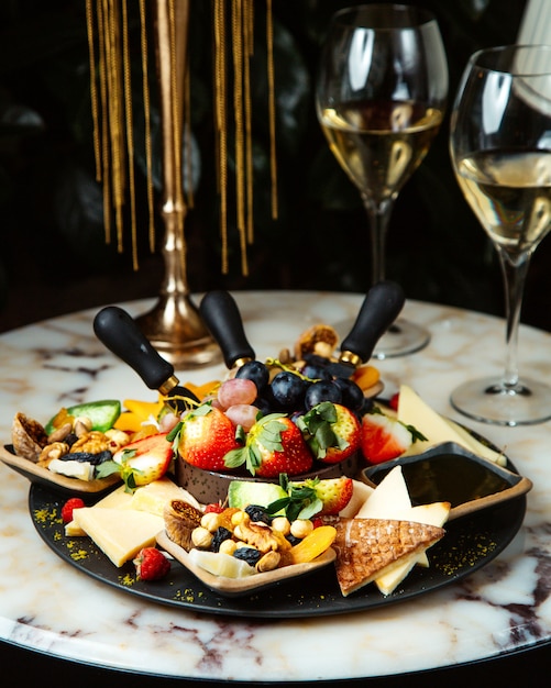 Free Photo | Champagne glasses and fruit plate