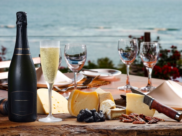 Premium Photo | Champagne with special cheeses on the beach