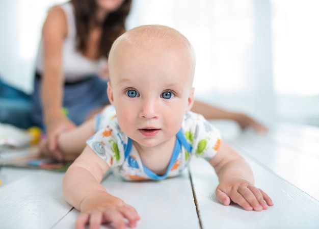 Premium Photo | Charming six-month-old baby crawls on the floor