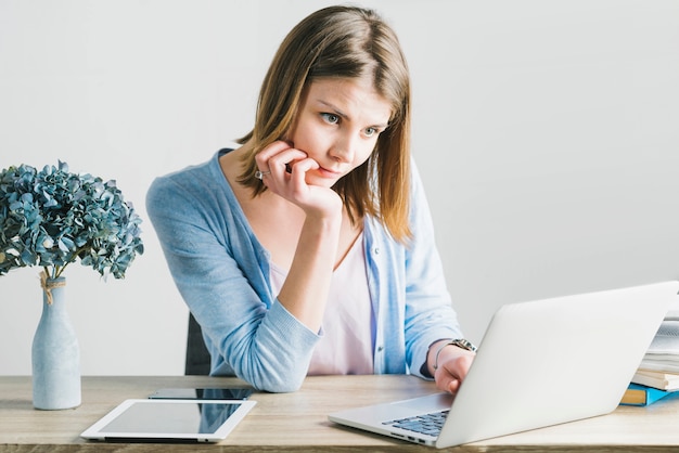 Free Photo | Charming woman thinking and using laptop