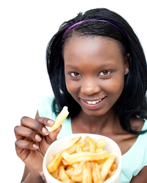 Premium Photo | Charming young woman eating fries