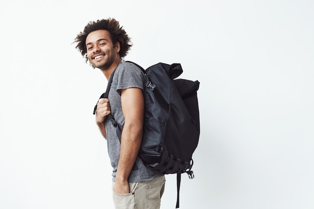 Cheerful african man with backpack smiling. Free Photo