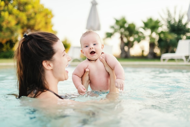 Premium Photo | Cheerful caucasian 6 months old baby boy learning how ...