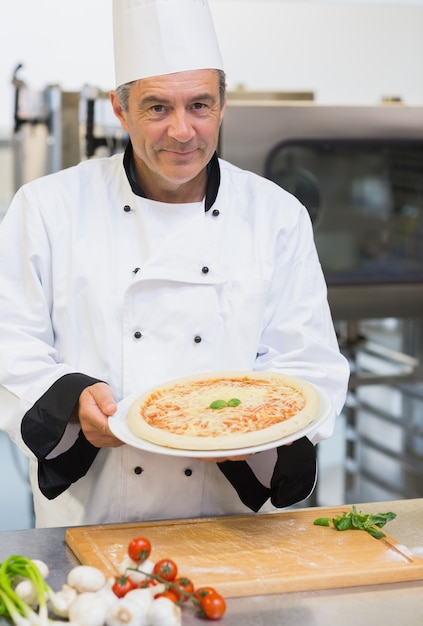 Premium Photo | Cheerful chef presenting pizza