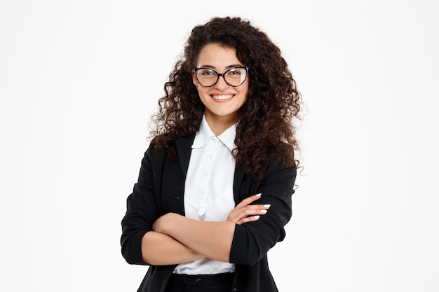 Cheerful curly business girl wearing glasses Free Photo
