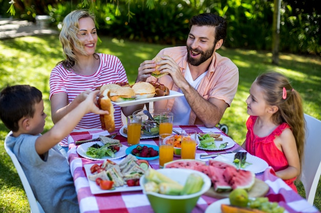 Premium Photo | Cheerful family enjoying meal in yard