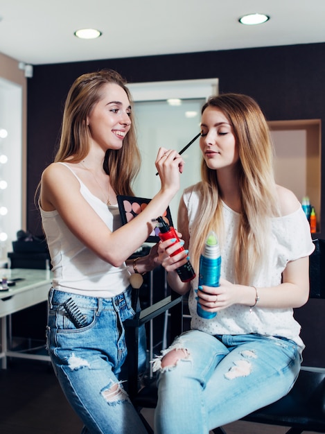 Premium Photo Cheerful Female Make Up Artist Applying Eyeshadows On