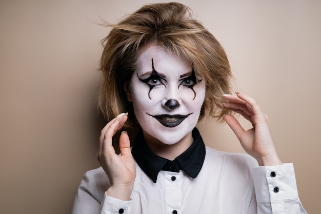 Premium Photo A Cheerful Girl In Halloween Makeup Smiles And Looks Straight 