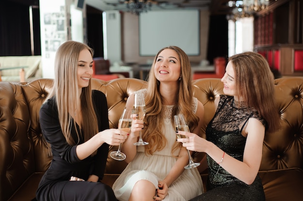 Premium Photo Cheerful Girls Clinking Glasses Of Champagne At The Party