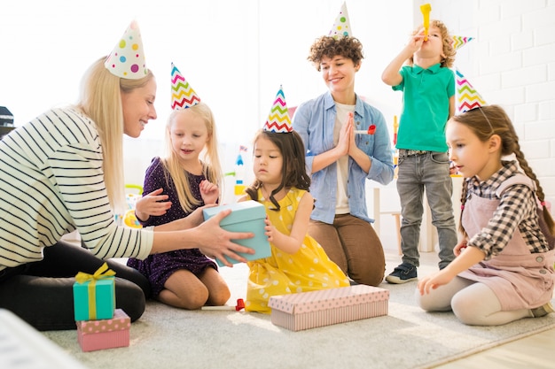 Premium Photo  Cheerful kids opening gift box at birthday party