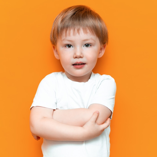 Cheerful Little Boy Child Standing Isolated Over Yellow Background