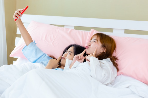 Cheerful Teenager Woman Use Smartphone Selfie On Bed Photo