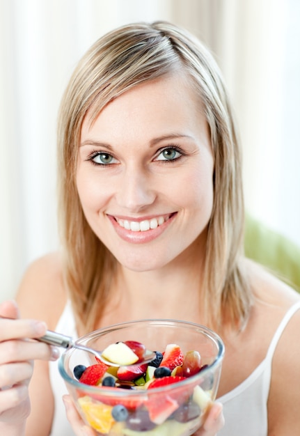 premium-photo-cheerful-woman-eating-a-fruit-salad