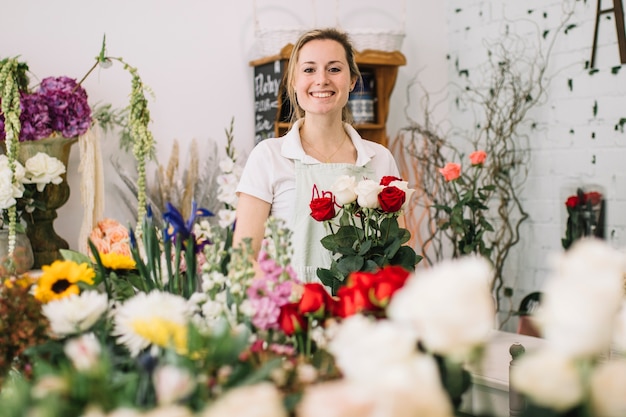 Cheerful worker of flower shop Photo | Free Download